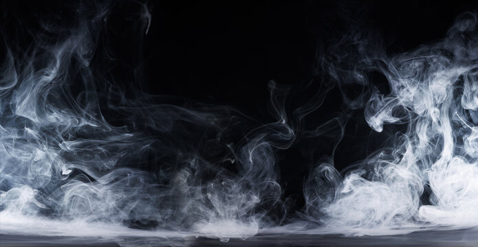 Panoramic view of the abstract fog. White cloudiness, mist or smog moves on black background. Beautiful swirling gray smoke. Mockup for your logo. Wide angle horizontal wallpaper or web banner.