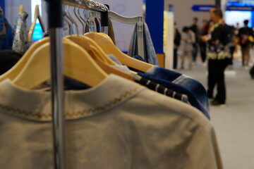 An array of Indonesian batik shirts and batik cloth hangs on the racks, displaying a variety of patterns and colors.