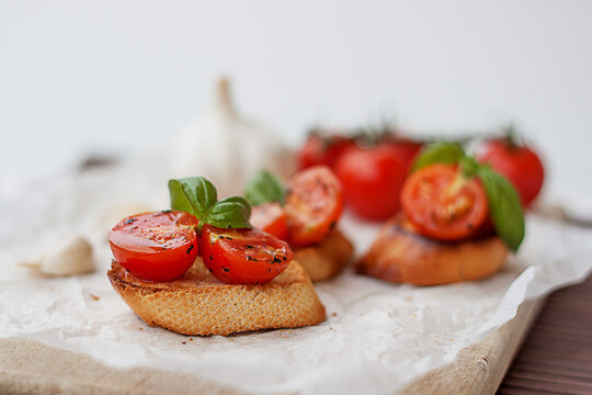 Close-up of bruschetta with fresh cherry tomatoes, basil and garlic