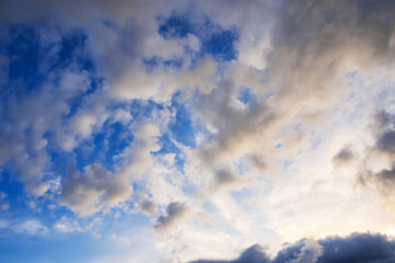 Fototapeta premium Blue sky with white clouds at sunset in summer