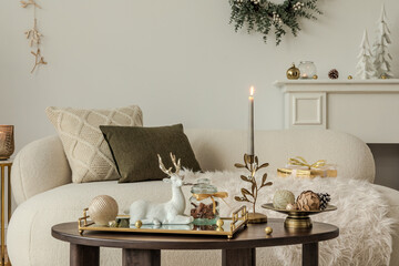 Cozy holiday living room with neutral tones, a soft sofa, and festive decor on a wooden coffee...