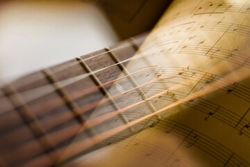 Paper sheets of music notes and classic guitar