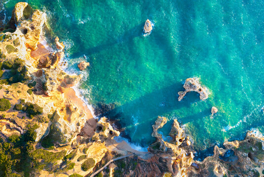 Top view of rock formation at Camilo beach in Algarve, Portugal during sunrise