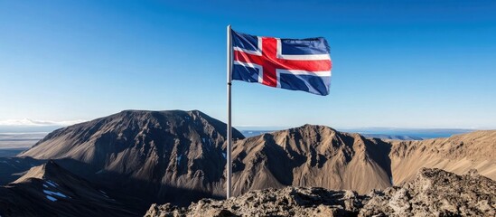 Icelandic flag flutters against the breathtaking backdrop of Landmannalaugar's colorful mountains and clear blue sky