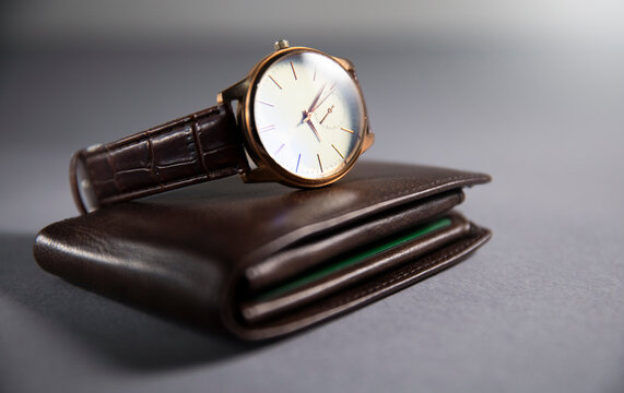 a pocket watch with a wallet