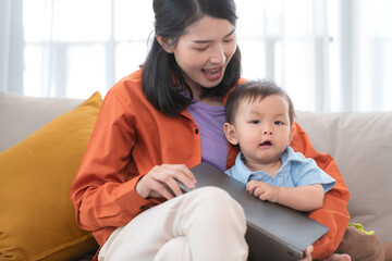 Fototapeta premium Mother and son play together after dad comes home from work
