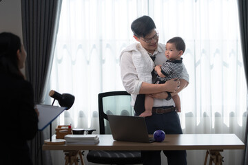 A business father assigns work to his secretary, while also taking care of his child while working