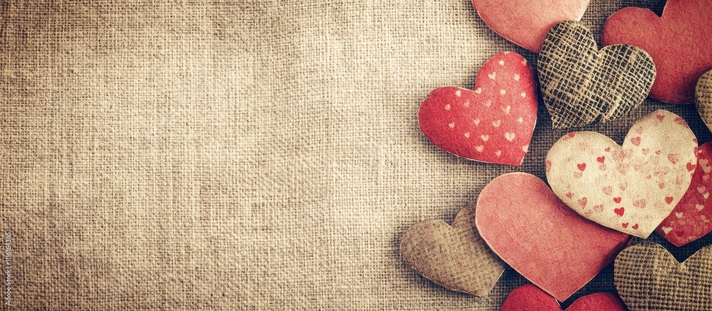 Poster vintage paper background adorned with assorted red and patterned hearts creating a warm and romantic