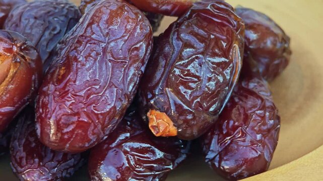 Dried dates fruits with wooden bowl.
