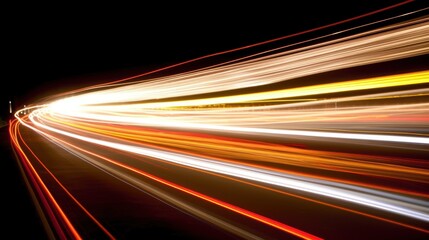 A long-exposure shot capturing dynamic light trails on a dark road.