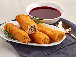 Golden-breaded croquettes filled with mushrooms and cabbage, served with a traditional beet soup (barszcz) on the side. A cozy, classic Polish holiday dish perfect for festive gatherings.
