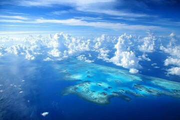 Breathtaking Aerial View of Turquoise Waters and Coral Reefs Under a Vast Blue Sky with Fluffy White Clouds in a Tropical Paradise Setting
