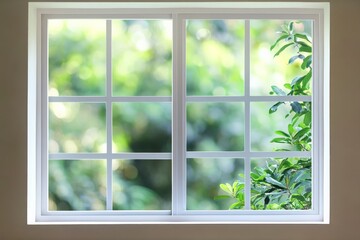 A modern house window showcasing a stunning green garden view.