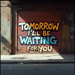 graffiti tomorrow ill be waiting for you appears in bold multicolored letters against brick wall creating dramatic urban promise