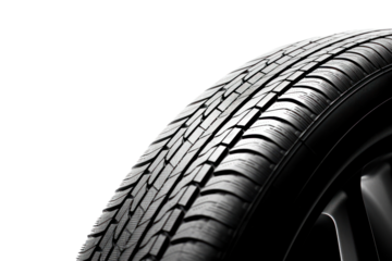An artistic perspective of a car tire with a focus on the tread, revealing the depth and texture. The tire is positioned at an angle to accentuate its profile and dynamic design