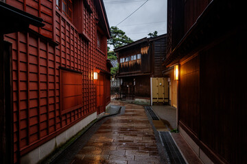 A beautiful and charming rainy alleyway featuring traditional Japanese architecture and ambiance