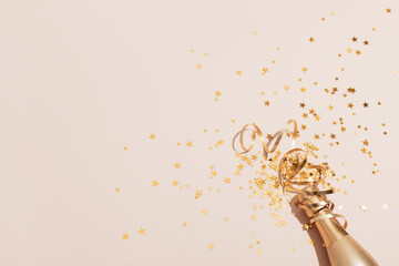 Party background with champagne and golden confetti stars. Christmas, birthday or wedding concept....