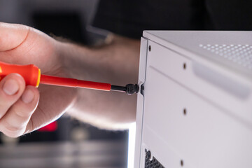 screwing pc case panel, screwdriver, hand tightening screw, computer assembly, case maintenance,...