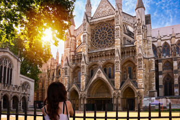 Young tourist looking at Westminster abbey in London city, England