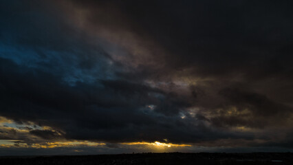 Fototapeta premium Sunset Behind Dark Cloud Cover