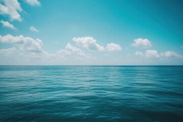 Fototapeta premium A serene view of calm ocean waters under a clear blue sky.