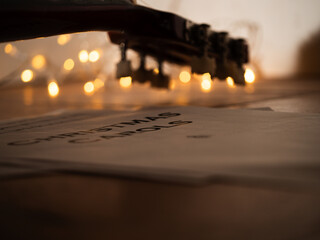 Acoustic guitar in front of Christmas lights 