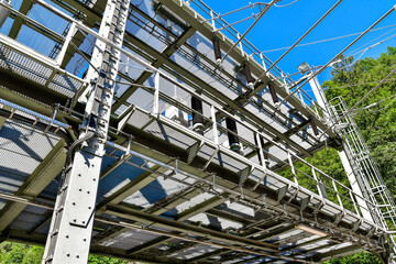 A black and white photo of a bridge with trees in the background
