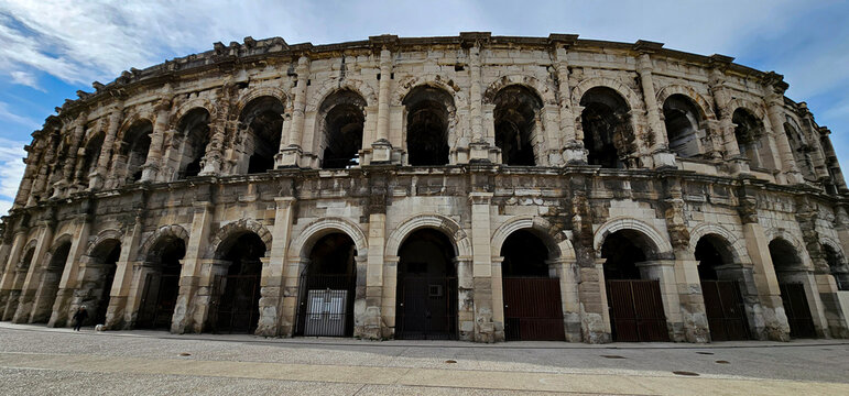 Amphitheatre in Nimes, France; exterior of Roman colosseum, amphitheatre or arena in Nimes, one of best preserved in world; famous, ancient Roman UNESCO landmark in France with no people.