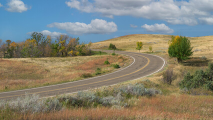 Scenic curved road through high praire grasslands of Theodore Roosevelt National Park North Unit near Watford City, North Dakota