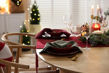 Christmas table setting with stylish dishware and festive decor indoors