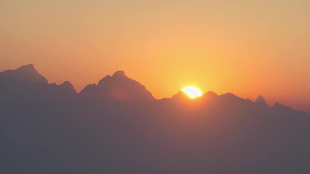Dawn on the Himalaya mountain range. The golden sun rise behind the peaks in a clean morning sky