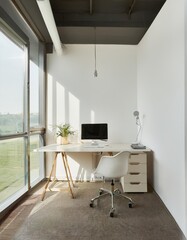 Office desk with computer equipment on it and also office chair located in an office room with bright white walls