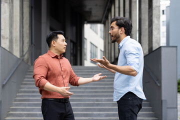 An intense exchange between two colleagues on office stairs captures a moment of workplace...