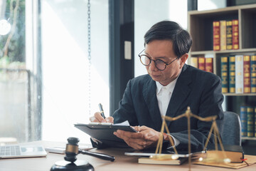 Focused Legal Counsel: A seasoned lawyer meticulously reviews documents, a symbol of justice and legal expertise.