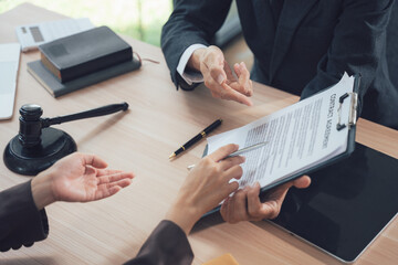 Legal Contract Review: Two professionals, a lawyer and a client, meticulously review legal...