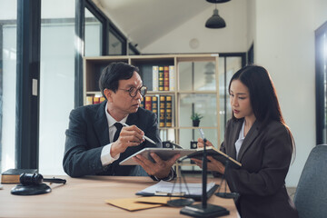 Lawyers Discussing Case: A professional male and female lawyer, both in suits, are discussing a...