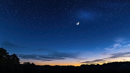 Naklejka premium A tranquil night sky filled with stars and a crescent moon over a serene landscape.