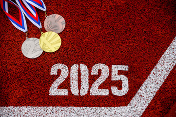 New Year 2025 Running motivation. Tittle 2025 on red running track and medal set on the track....