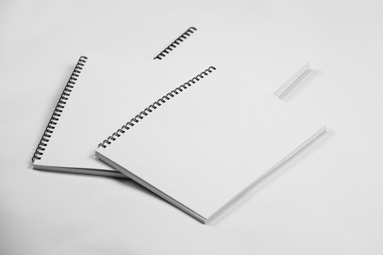 Set of closed spiral bound books, isolated on white background
