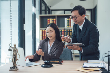 Lawyers Collaborating: A focused and professional image of two lawyers in a modern office, collaborating on a legal case.