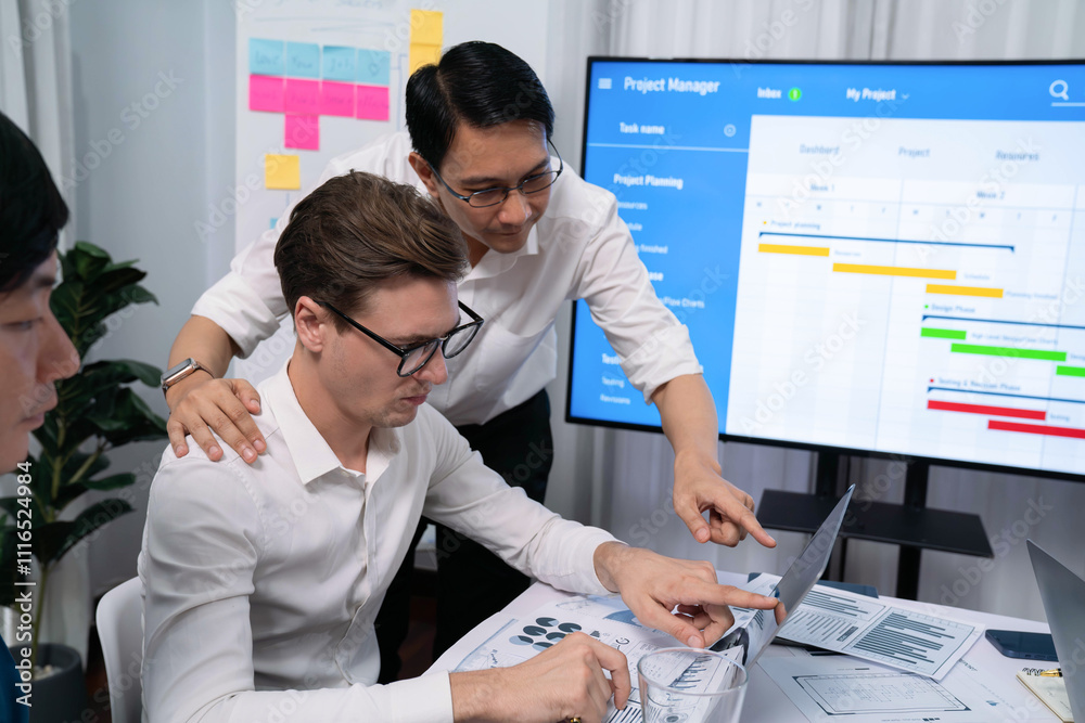 Leinwandbilder Project manager communicate and collaborate with team using project management software display on monitor, tracking progress of project task and making schedule plan at meeting table. Prudent