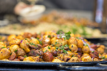 Street food. Grilled meat and side dish on a large pan for sale at the market