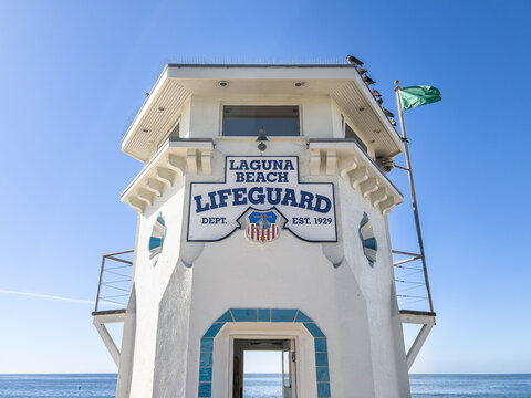 Laguna Beach, CA, USA - November 14, 2024: A Laguna Beach Lifeguard tower on the beach with the Pacific Ocean in the background.
