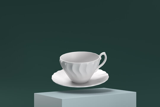 A white cup and saucer are suspended in midair
