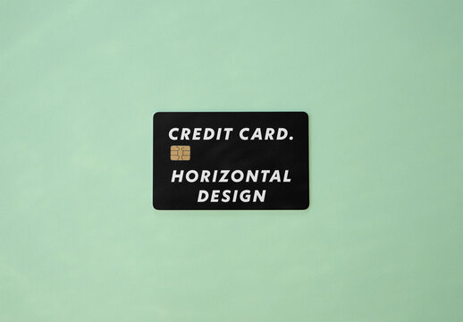 Horizontal credit Card Resting on Mint Green Surface