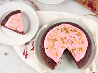 Piece of beetroot chocolate cake with pink cream cheese icing © tenkende
