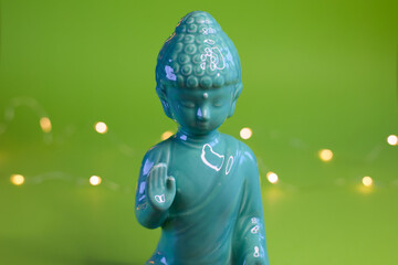 A Serene, Beautiful Buddha Statue on a Vibrant Green Background with Soft, Gentle Lights