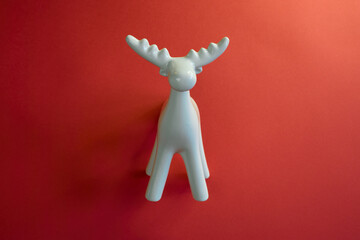 A Stylish White Moose Figurine Set Against a Bright Red Background to Enhance Its Appeal