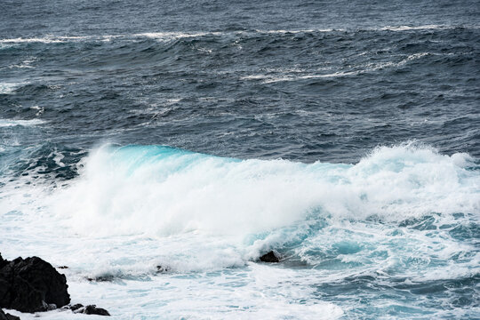 North coast of Tenerife, Canary Islands, waves breaking against dark lava rocks.