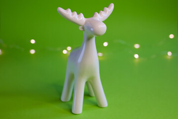 Stylized White Moose Figurine displayed on a vibrant Green Background for artistic appeal